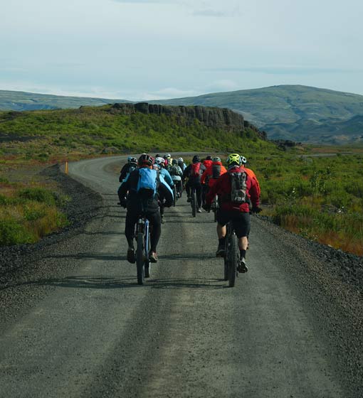 Group of bikers riding in a gravel road close to Þjórsárdalur